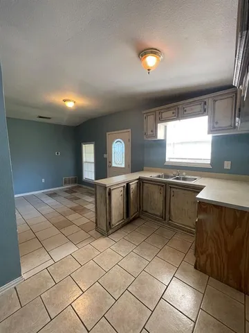 a kitchen with stainless steel appliances granite countertop a sink counter space and a window