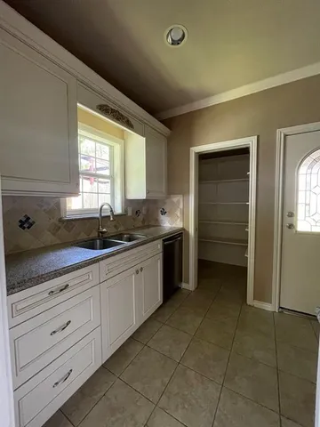 a kitchen with a sink and cabinets