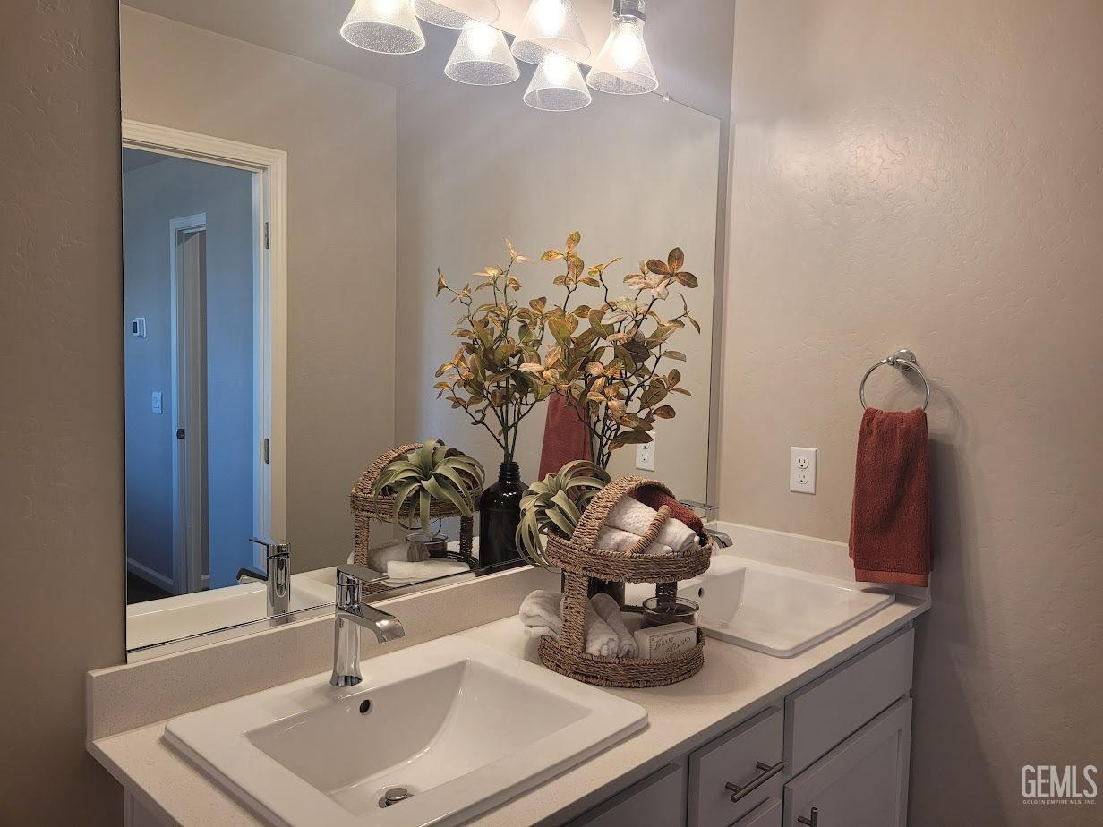 Undisclosed Address Bakersfield, CA 93313 - Photo 15 of 25 a bathroom with a sink and a mirror