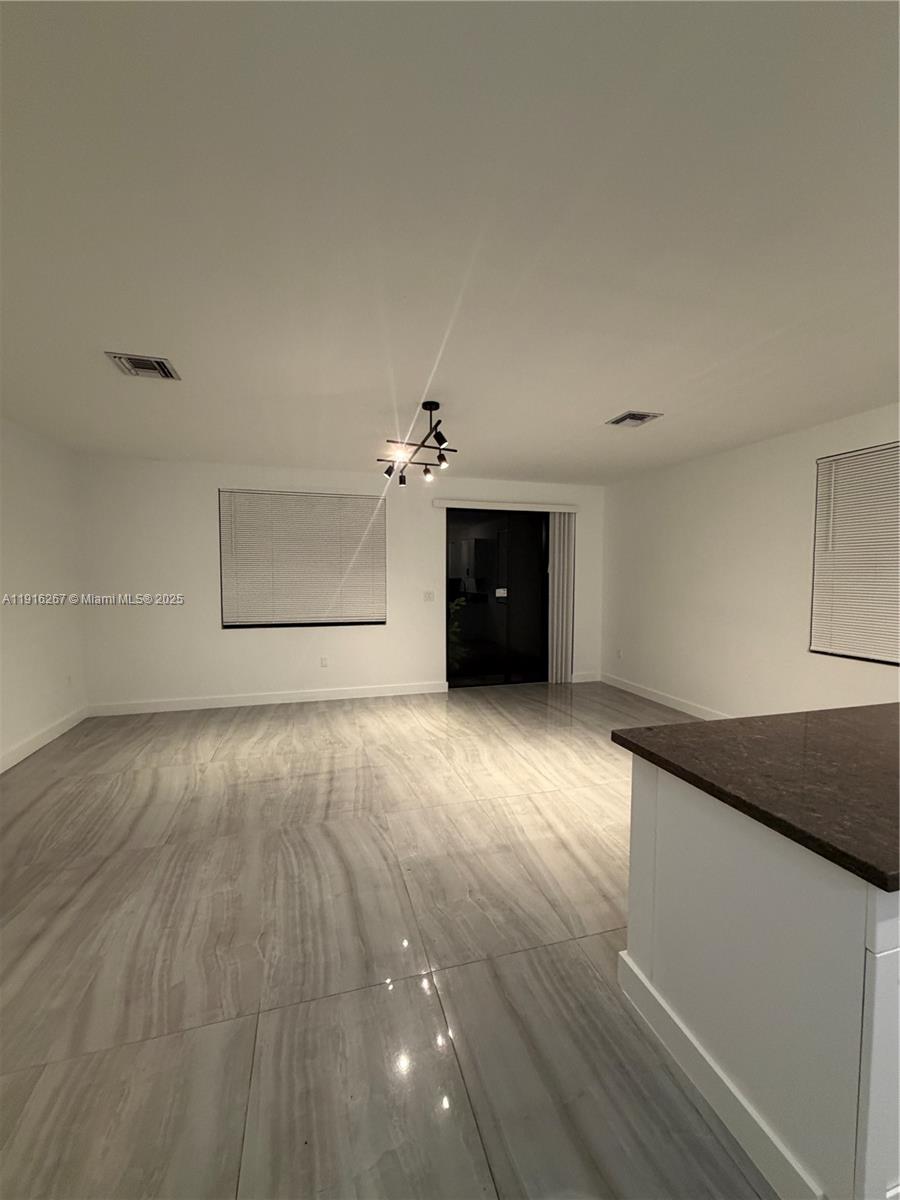 932 Southwest 10th Street, Unit 3 Hallandale Beach, FL 33009 - Photo 21 of 22 a view of a livingroom with a dishwasher cabinets and wooden floor