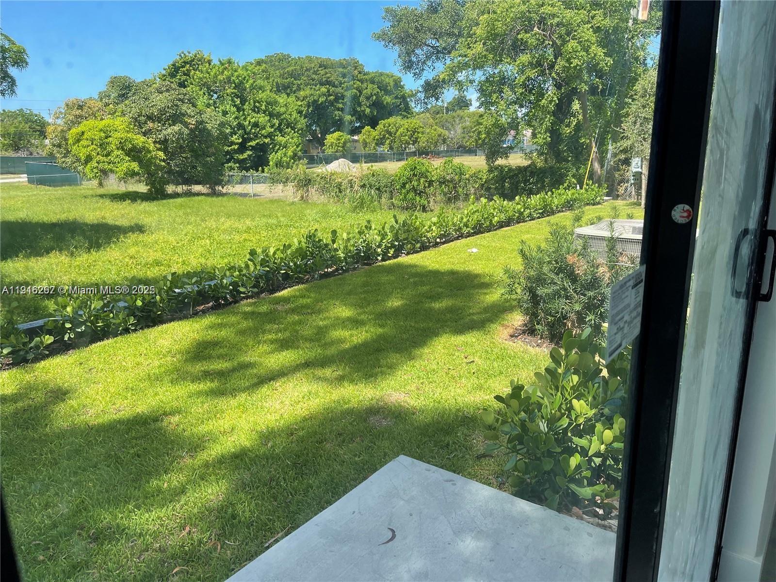 932 Southwest 10th Street, Unit 3 Hallandale Beach, FL 33009 - Photo 22 of 22 a view of yard with green space