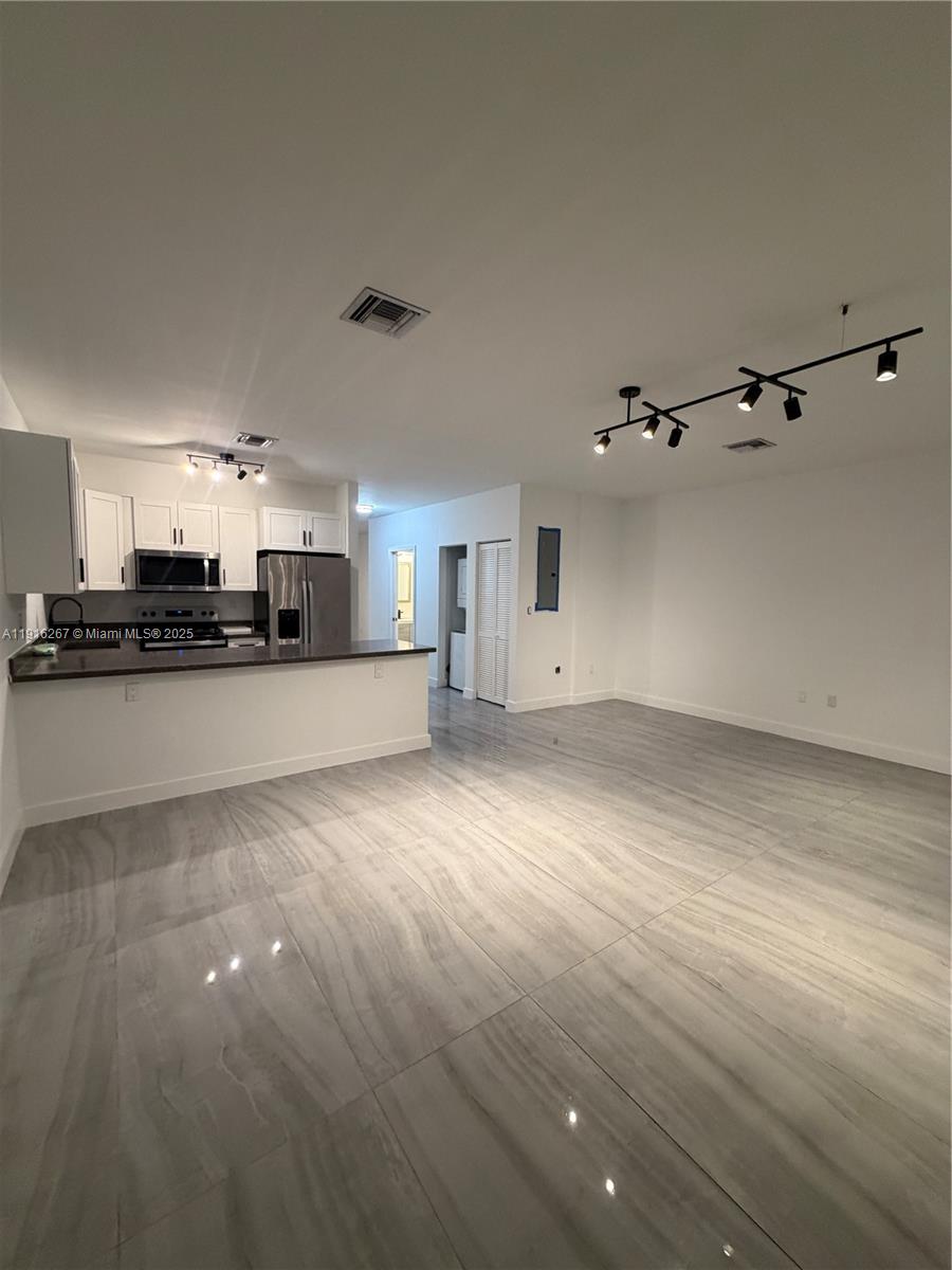 932 Southwest 10th Street, Unit 3 Hallandale Beach, FL 33009 - Photo 3 of 22 a view of a kitchen with an empty space