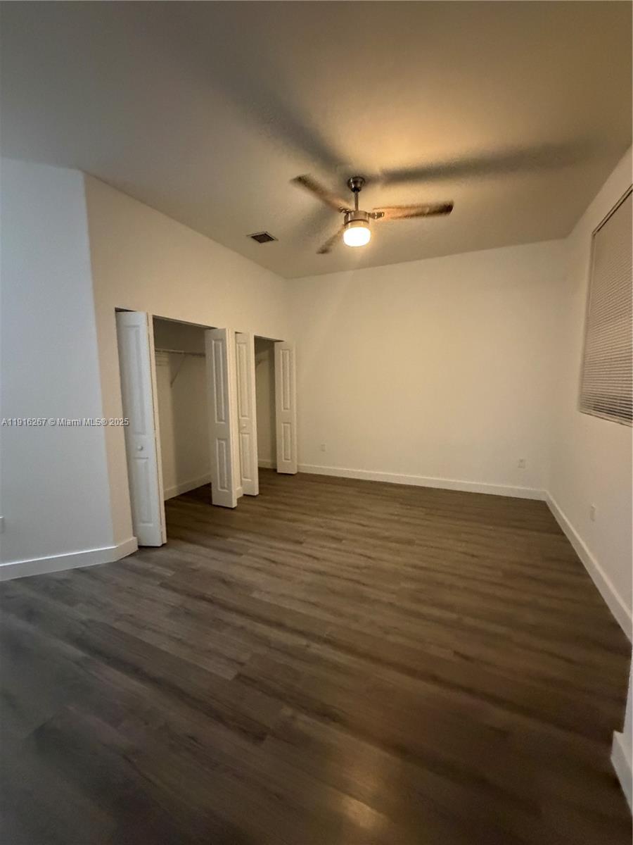 932 Southwest 10th Street, Unit 3 Hallandale Beach, FL 33009 - Photo 7 of 22 a view of an empty room with wooden floor