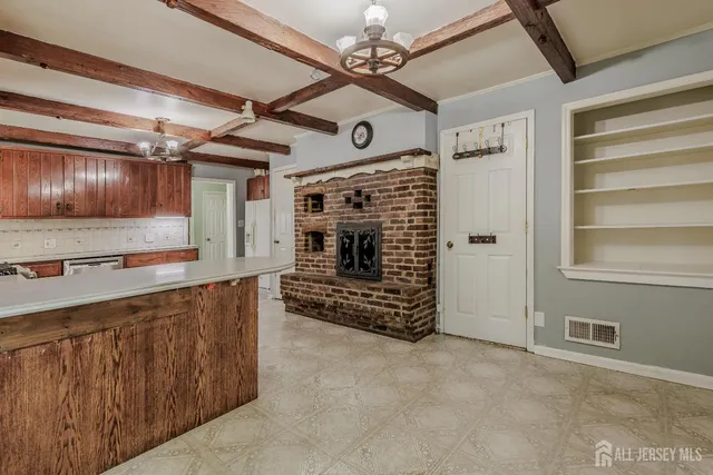 a view of an empty room with a fireplace