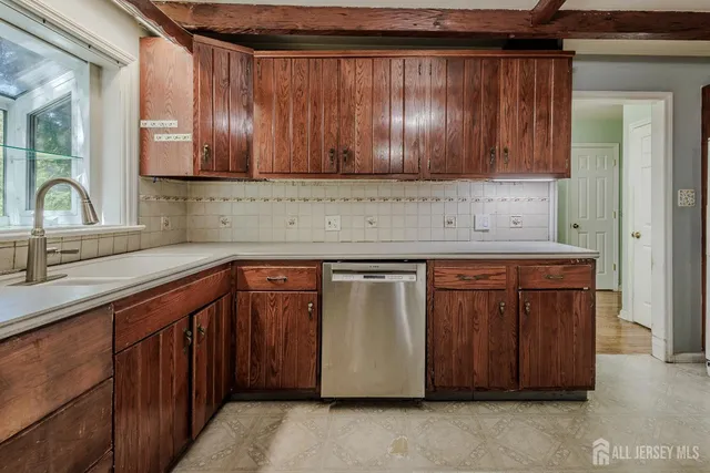 a kitchen with stainless steel appliances granite countertop wooden cabinets a sink and dishwasher