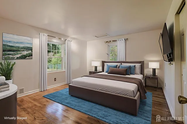 a bedroom with a bed wooden floor and window