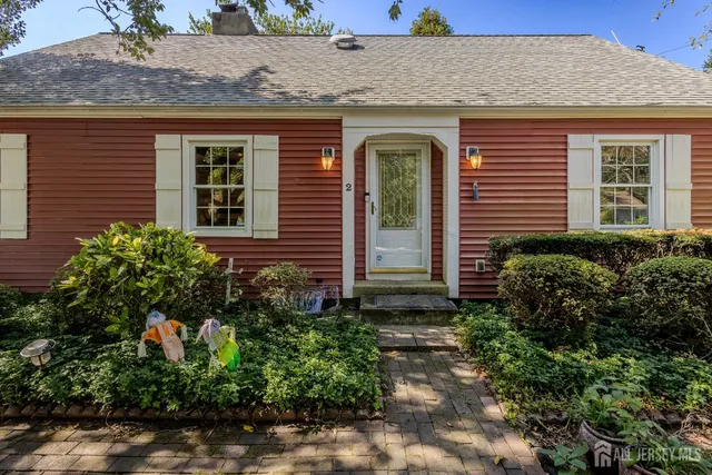 a front view of a house with plants