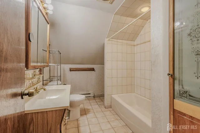 a bathroom with a sink a toilet and bathtub