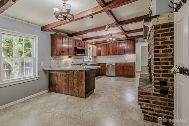 a view of kitchen with sink cabinets and window