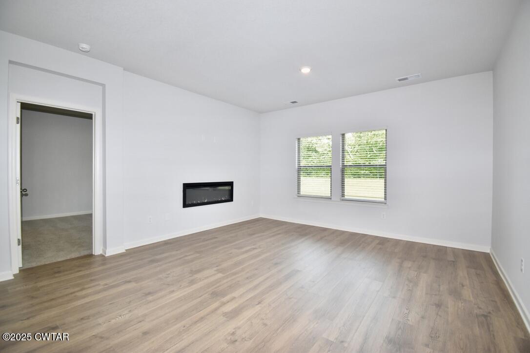 44 Clarendon Cove Jackson, TN 38305 - Photo 2 of 17 an empty room with wooden floor and windows