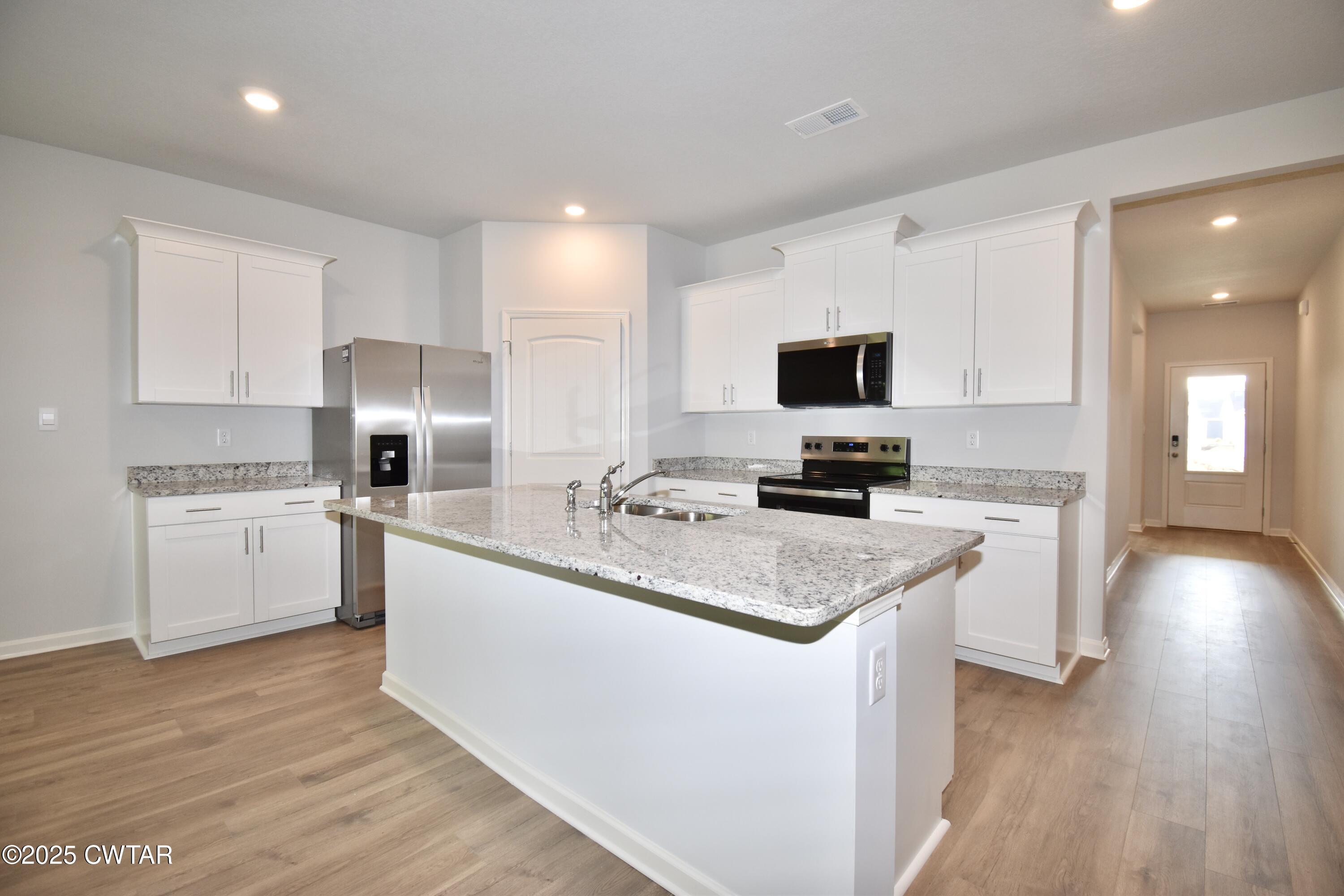 44 Clarendon Cove Jackson, TN 38305 - Photo 3 of 17 a kitchen with a sink a counter top space cabinets and stainless steel appliances