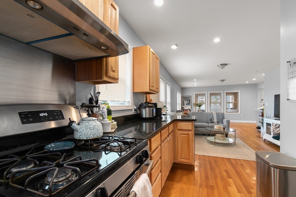 36-38 Priesing Street, Unit 2 Boston, MA 02130 - Photo 1 of 18 a kitchen with stainless steel appliances granite countertop a stove and a sink