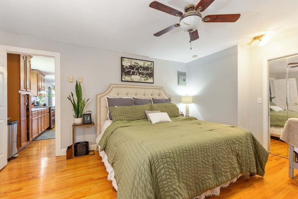 36-38 Priesing Street, Unit 2 Boston, MA 02130 - Photo 14 of 18 a bedroom with a bed and a chandelier