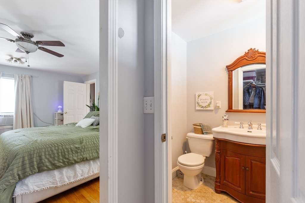 36-38 Priesing Street, Unit 2 Boston, MA 02130 - Photo 17 of 18 a bathroom with a toilet sink and mirror