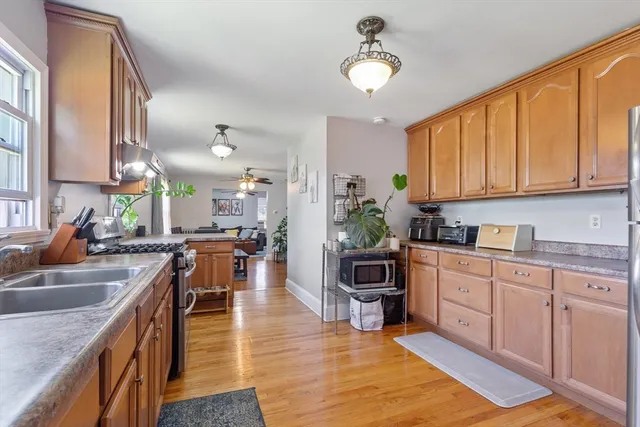 a kitchen with stainless steel appliances granite countertop sink stove top oven and cabinets