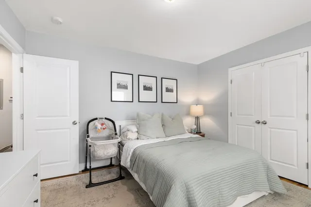 a bedroom with a bed and a lamp