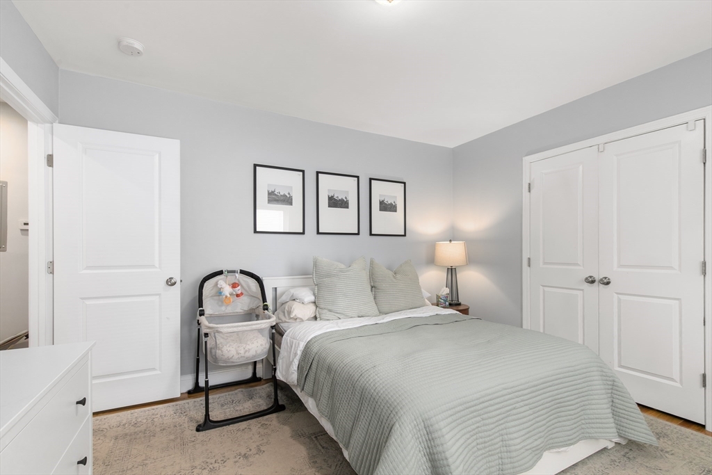 36-38 Priesing Street, Unit 2 Boston, MA 02130 - Photo 8 of 18 a bedroom with a bed and a lamp