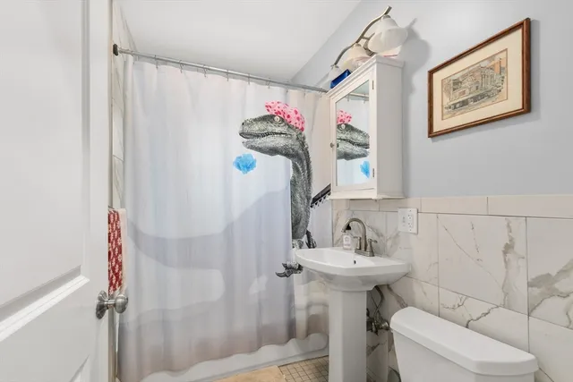 a bathroom with a sink mirror and toilet