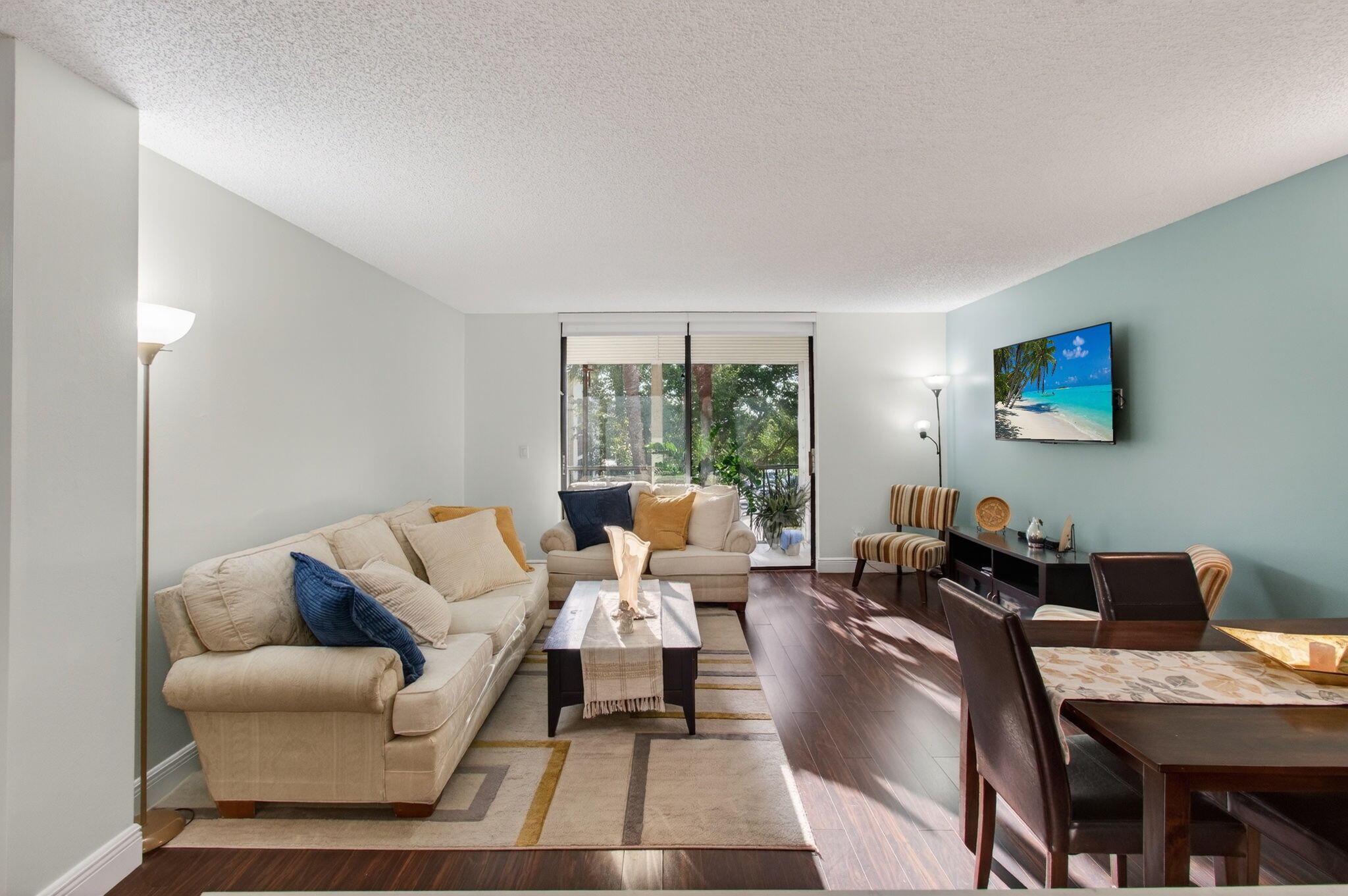 5220 Las Verdes Circle, Unit 322 Delray Beach, FL 33484 - Photo 12 of 65 a living room with furniture and a lamp