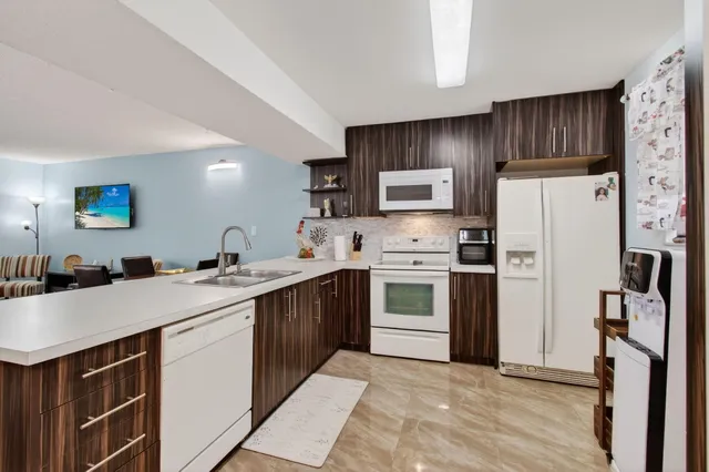 a kitchen with stainless steel appliances a refrigerator sink and microwave