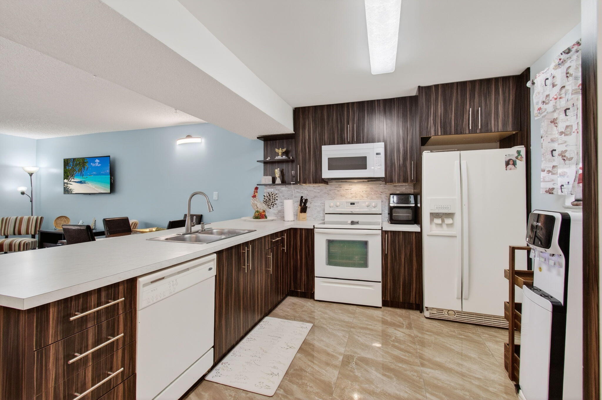 5220 Las Verdes Circle, Unit 322 Delray Beach, FL 33484 - Photo 19 of 65 a kitchen with a sink a refrigerator and a stove