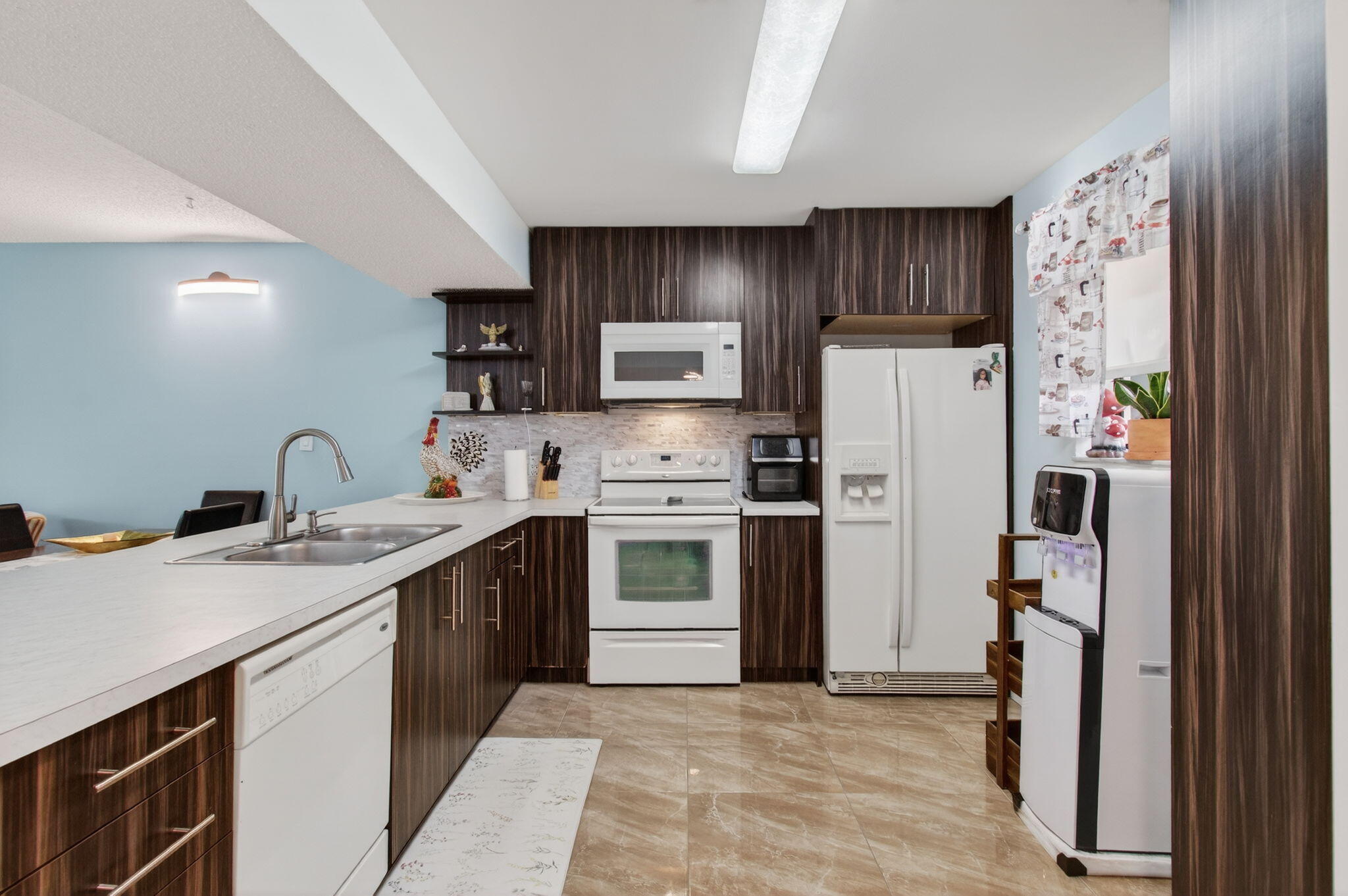 5220 Las Verdes Circle, Unit 322 Delray Beach, FL 33484 - Photo 20 of 65 a kitchen with stainless steel appliances a refrigerator stove and sink