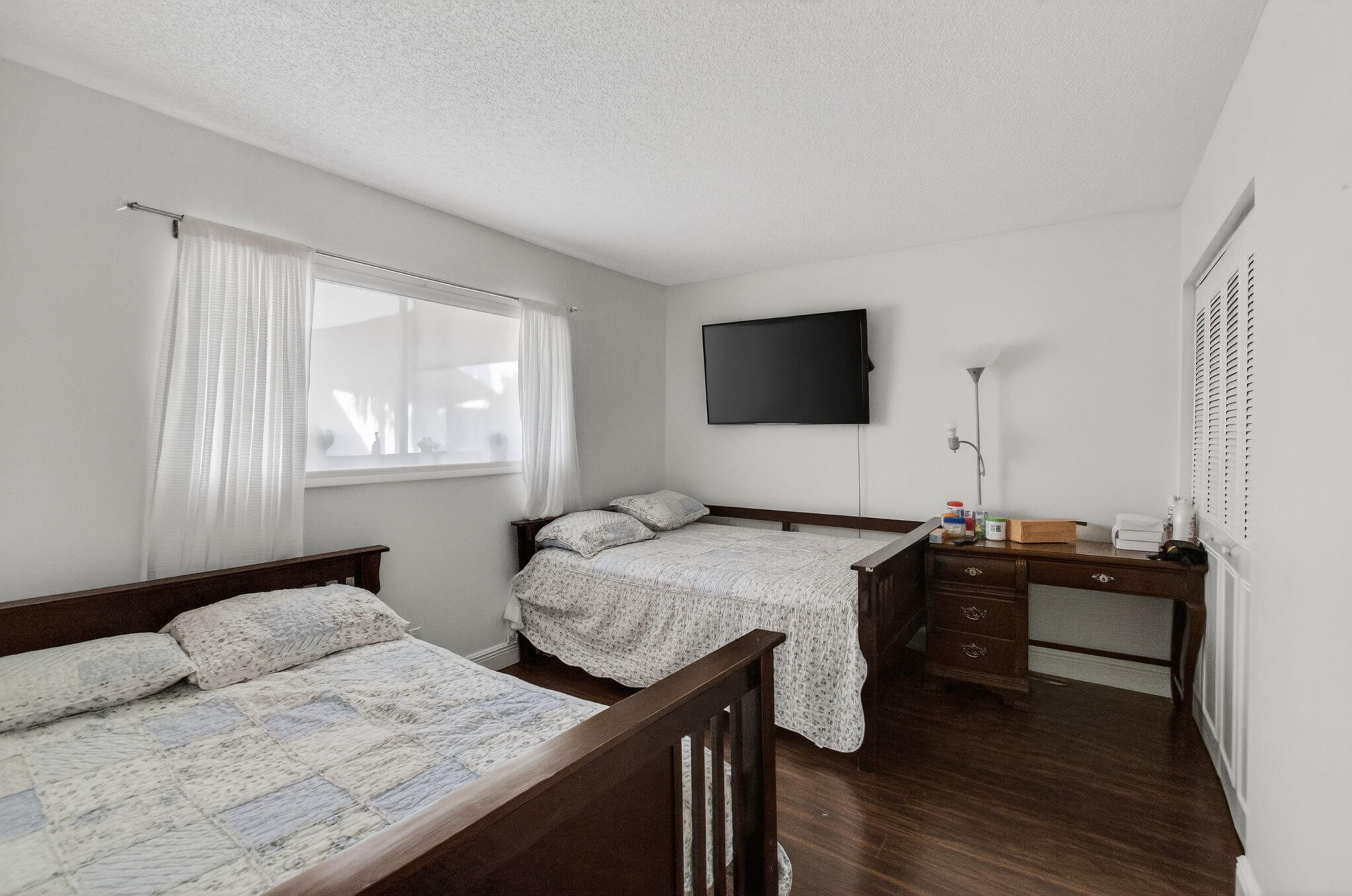 5220 Las Verdes Circle, Unit 322 Delray Beach, FL 33484 - Photo 24 of 65 a bedroom with a bed and wooden floor