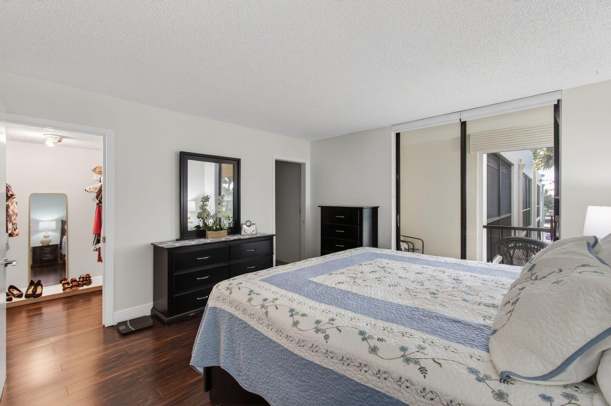 5220 Las Verdes Circle, Unit 322 Delray Beach, FL 33484 - Photo 30 of 65 a bedroom with a bed and wooden floor