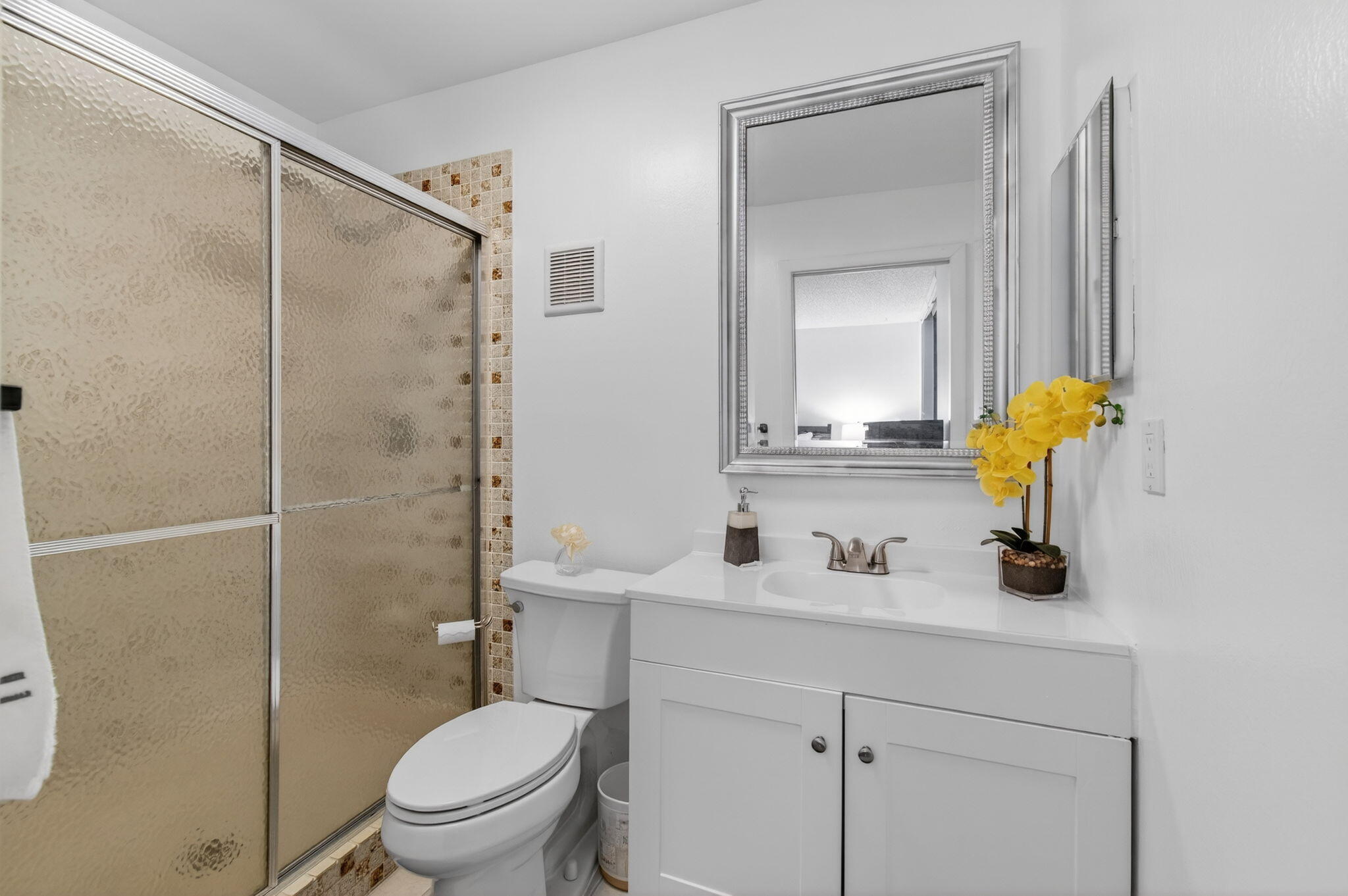 5220 Las Verdes Circle, Unit 322 Delray Beach, FL 33484 - Photo 32 of 65 a bathroom with a sink toilet and mirror