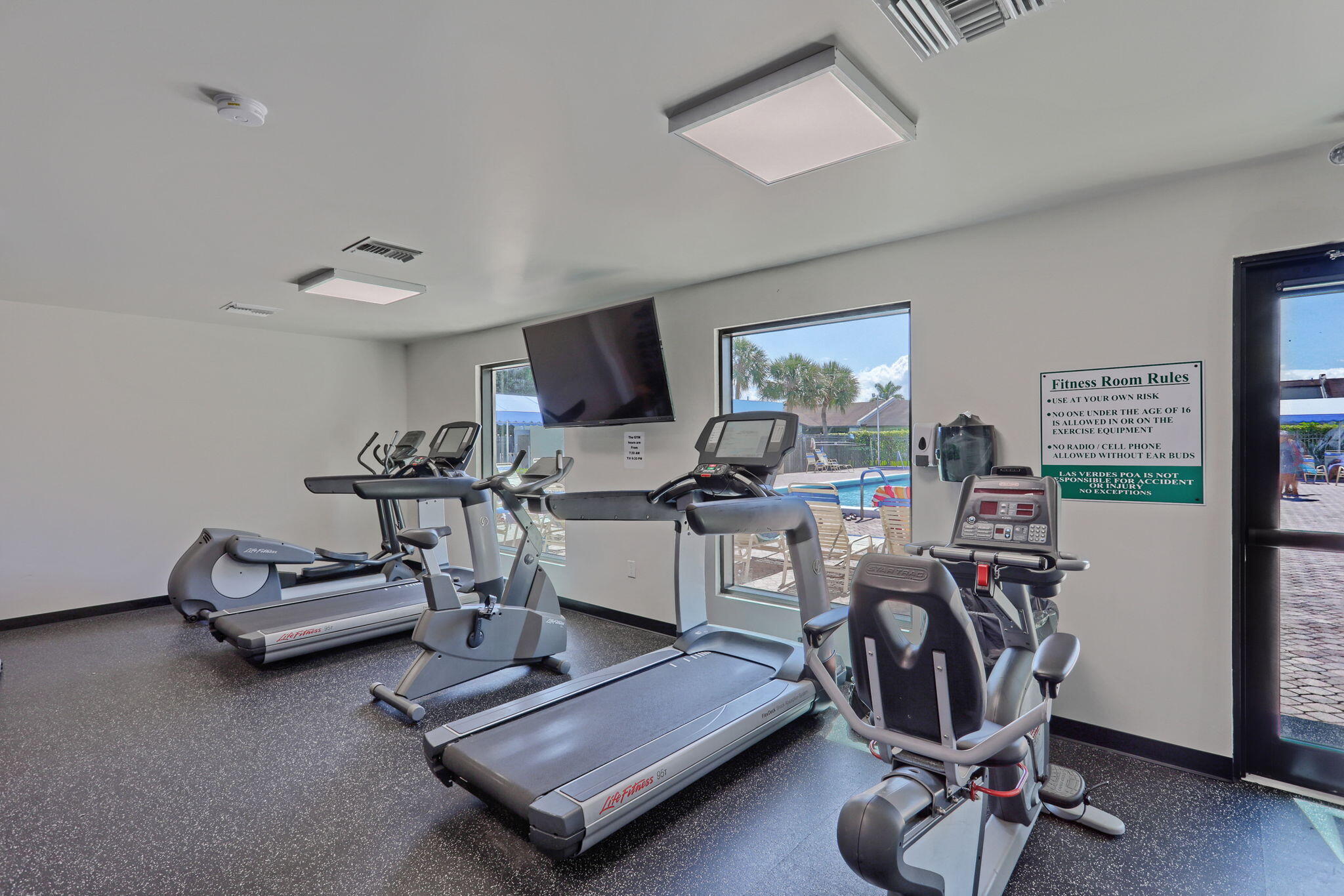 5220 Las Verdes Circle, Unit 322 Delray Beach, FL 33484 - Photo 47 of 65 a living room with furniture a rug and gym equipment