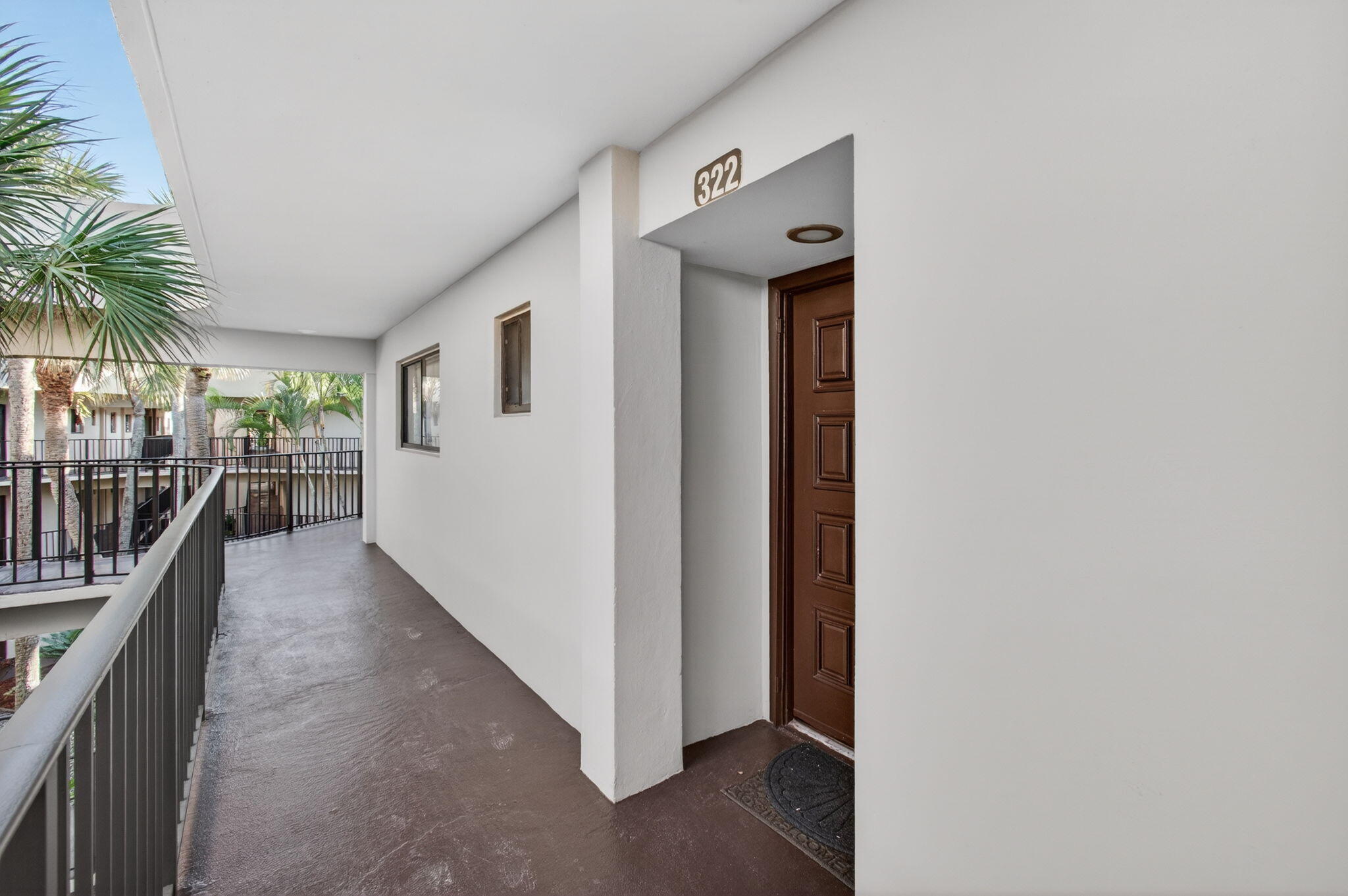 5220 Las Verdes Circle, Unit 322 Delray Beach, FL 33484 - Photo 5 of 65 a view of a hallway with wooden floor and entryway