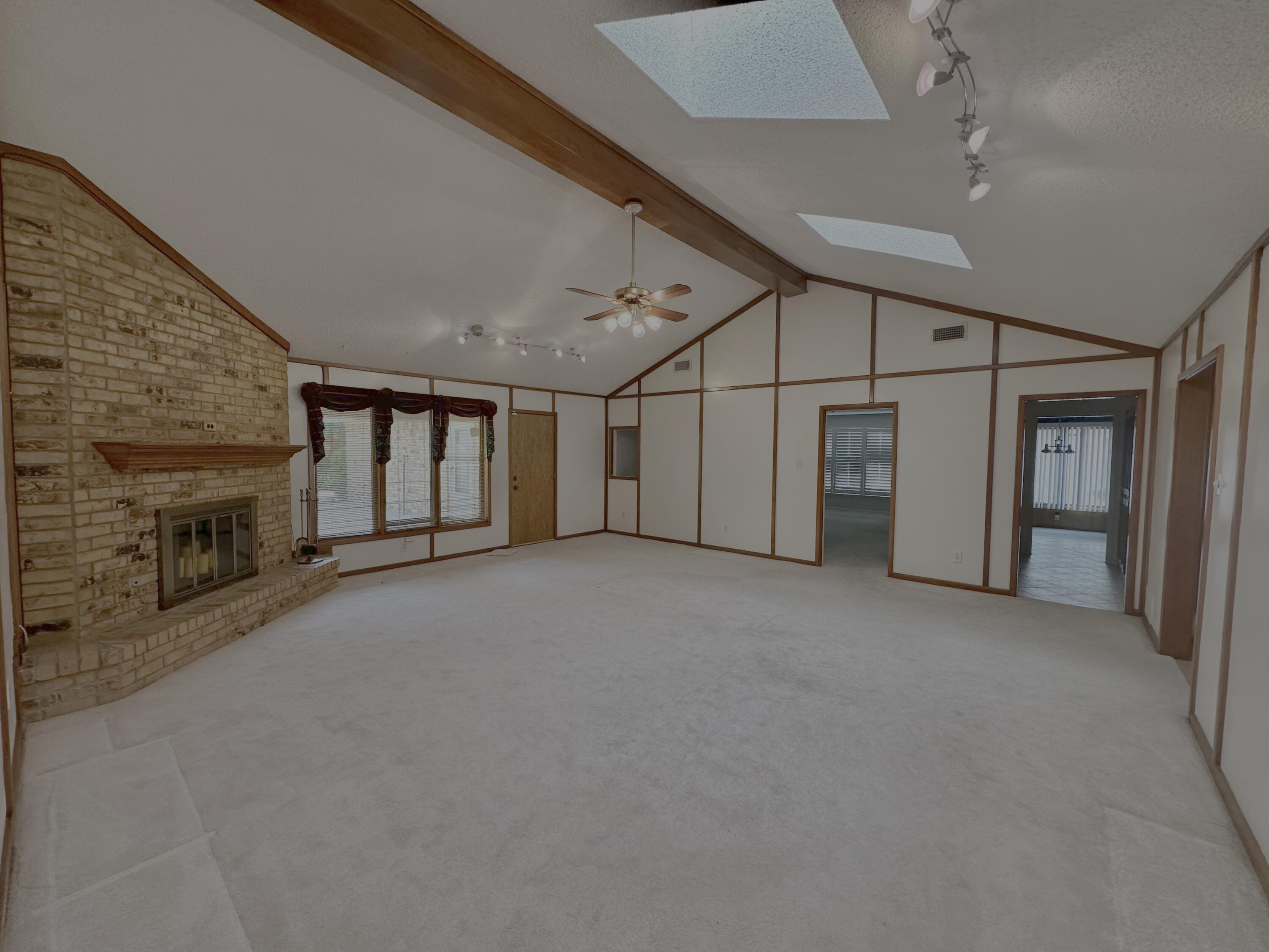 4610 88th Street Lubbock, TX 79424 - Photo 3 of 20 a view of a livingroom with fireplace and a ceiling fan