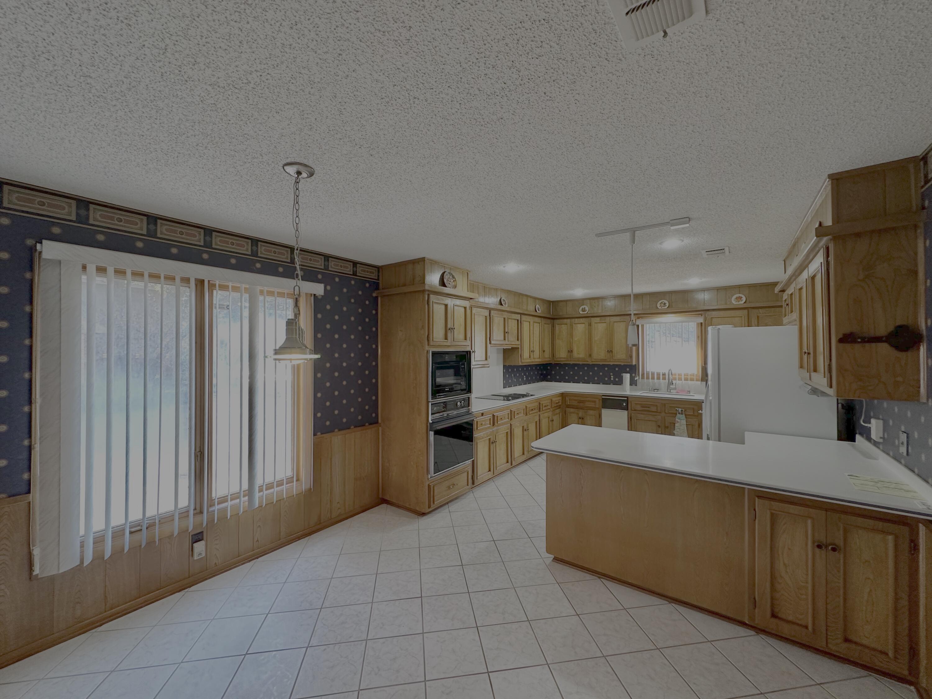 4610 88th Street Lubbock, TX 79424 - Photo 5 of 20 a large kitchen with stainless steel appliances a refrigerator and a stove top oven