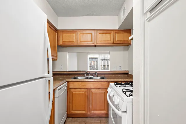 a kitchen with stainless steel appliances granite countertop a stove and a microwave