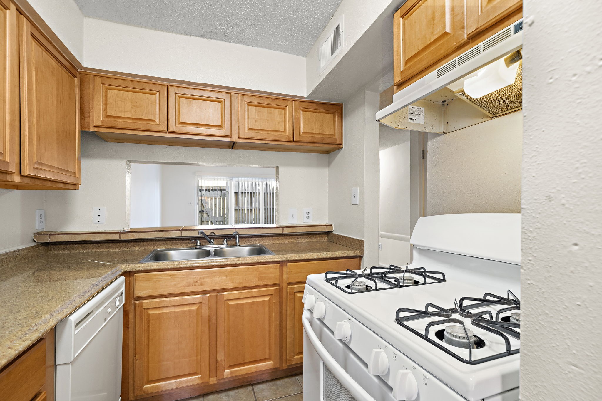 711 Holiday Drive, Unit 42 Galveston, TX 77550 - Photo 4 of 13 a kitchen with stainless steel appliances granite countertop a stove and a sink
