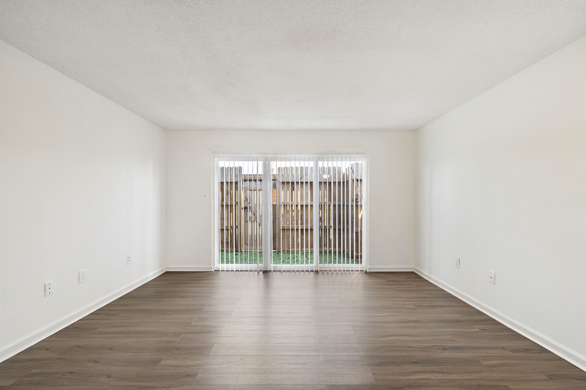 711 Holiday Drive, Unit 42 Galveston, TX 77550 - Photo 5 of 13 a view of wooden floor and chandelier in a room