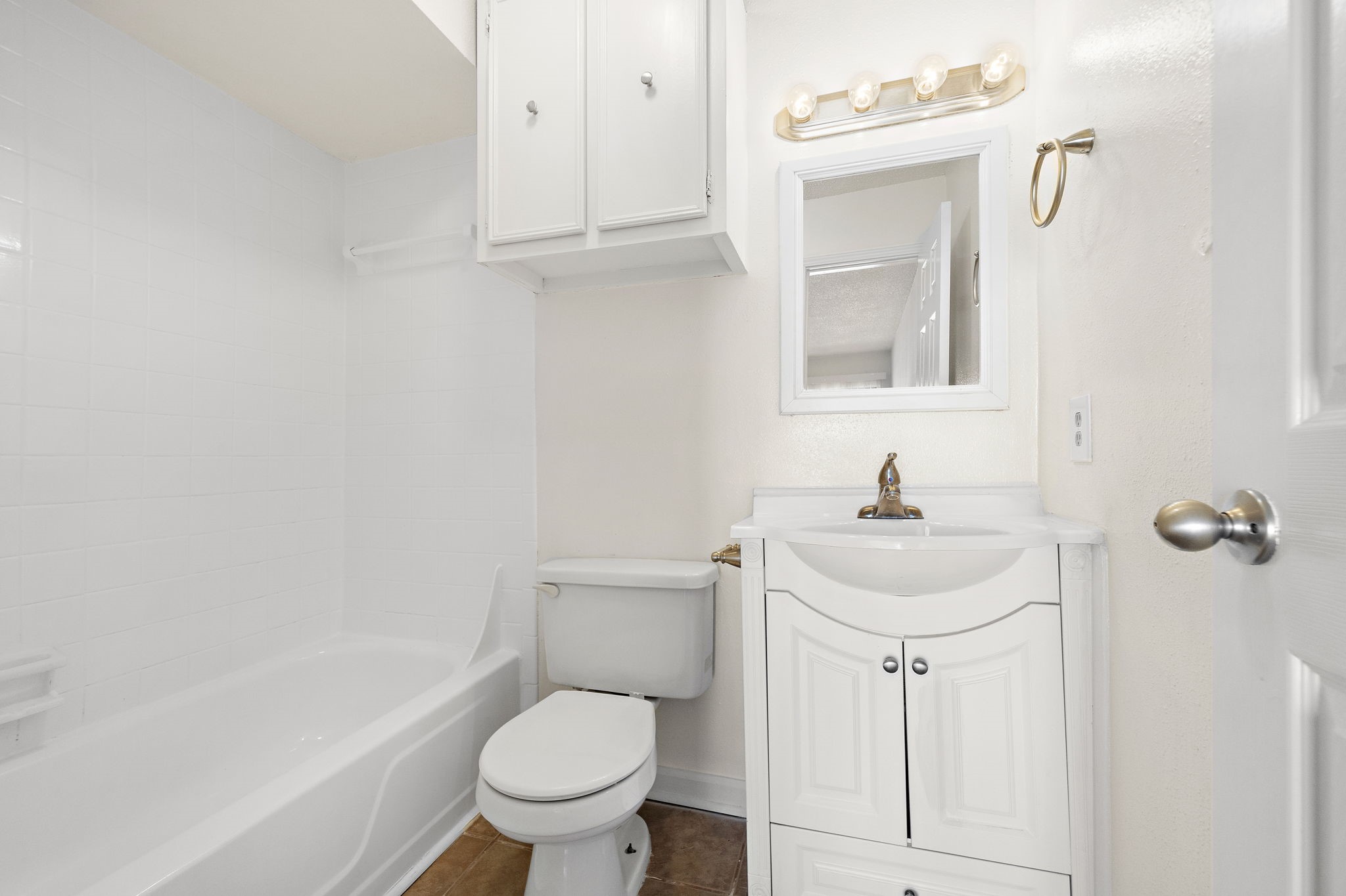 711 Holiday Drive, Unit 42 Galveston, TX 77550 - Photo 9 of 13 a bathroom with a sink a toilet and shower