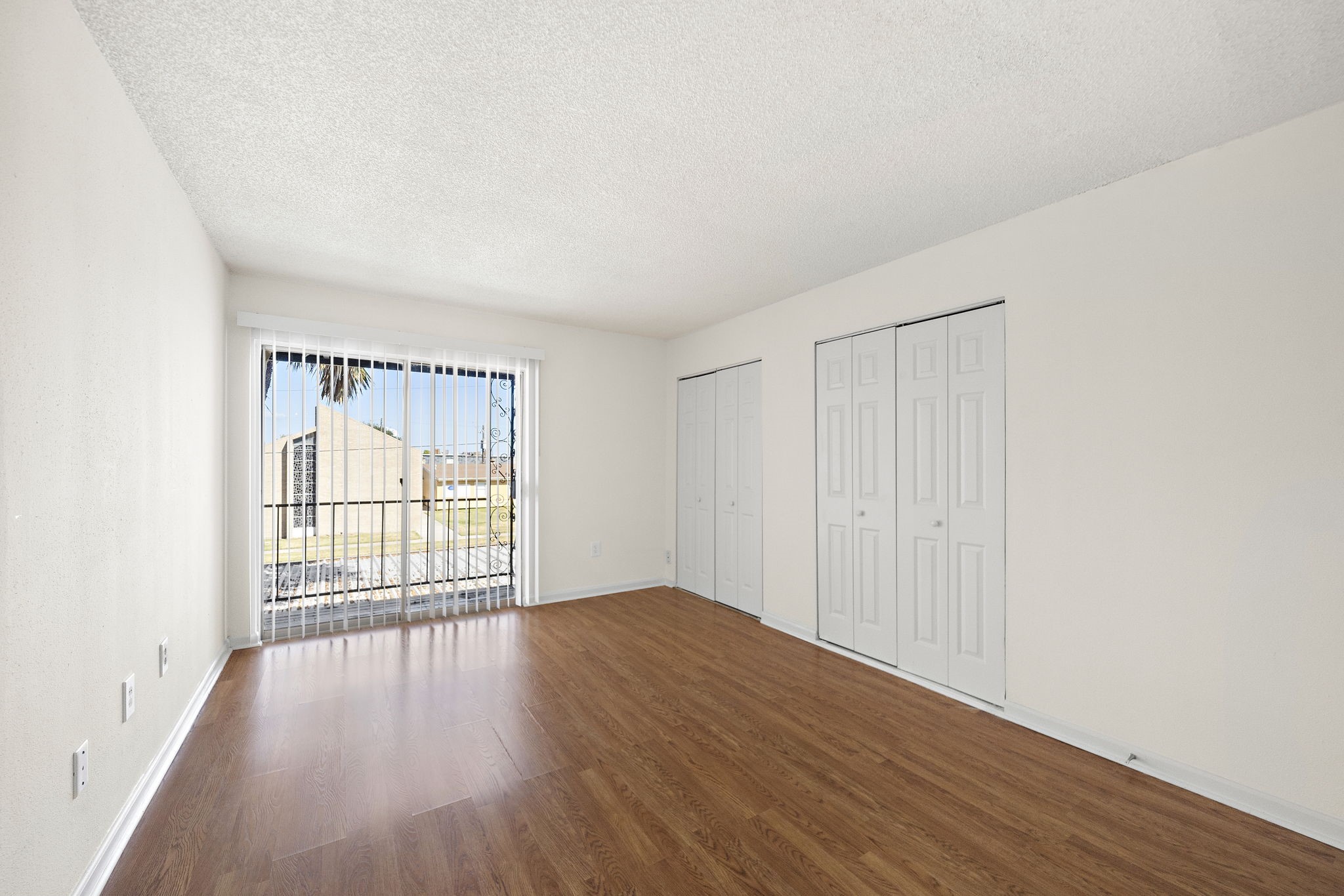 711 Holiday Drive, Unit 42 Galveston, TX 77550 - Photo 10 of 13 wooden floor in an empty room with a window