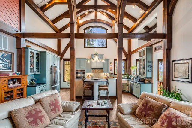 a living room with furniture a fireplace and a chandelier