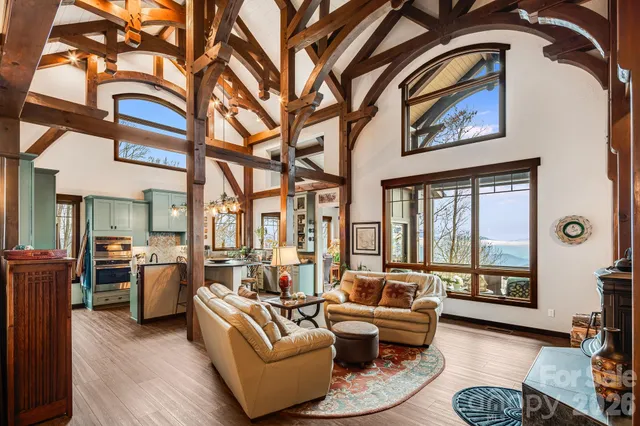 a living room with furniture and large windows