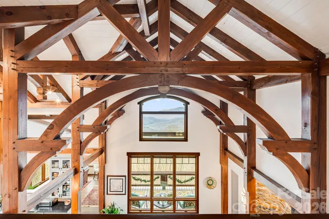 a room with furniture a large window and flat screen tv