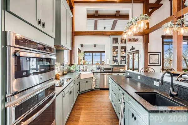 a kitchen with a large window and cabinets