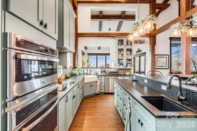 a kitchen with a large window and cabinets