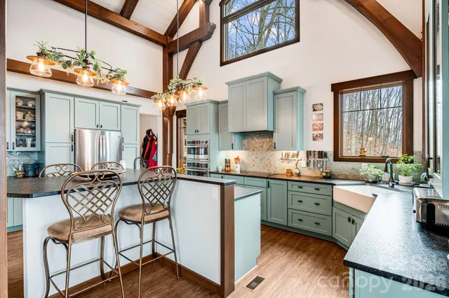 a living room with furniture and large windows