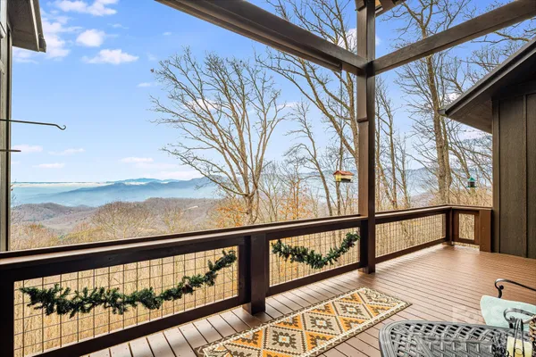 a balcony view with furniture and wooden floor