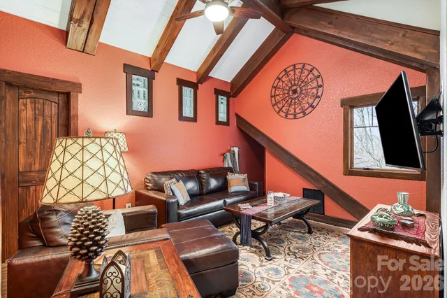 a view of a hallway with wooden floor and windows
