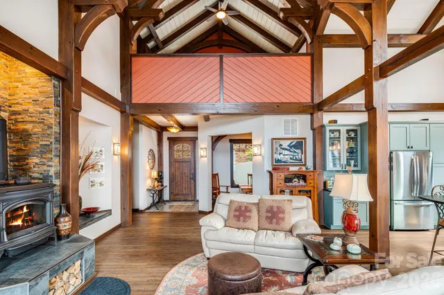 a living room with fireplace furniture and a floor to ceiling window