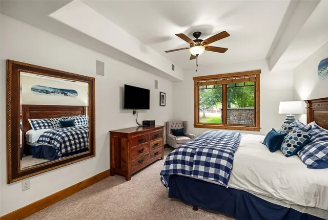 a bedroom with a bed dresser and a window