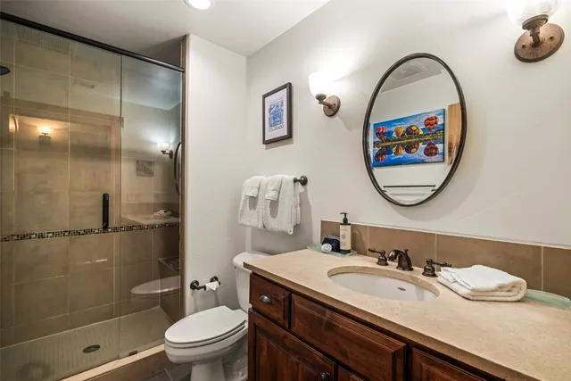 a bathroom with a toilet a sink and a mirror