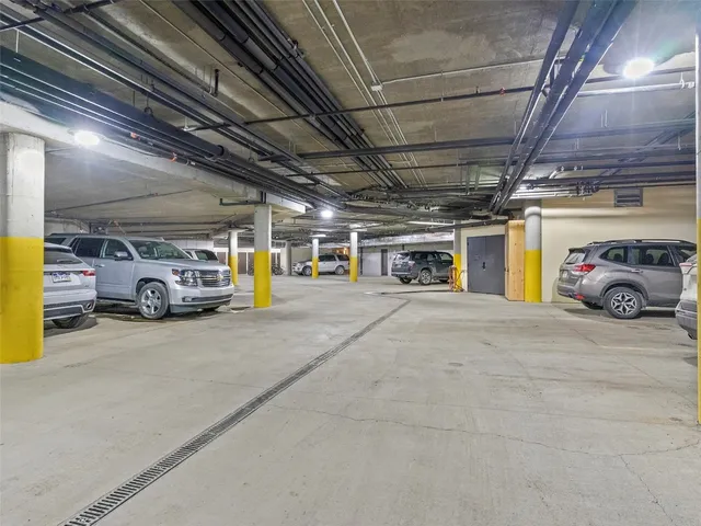 a view of parking garage with cars